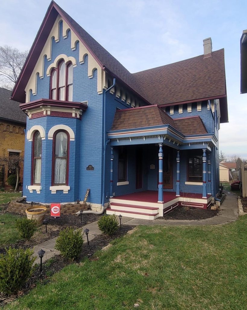 old home in dayton with blue and red painted exterior