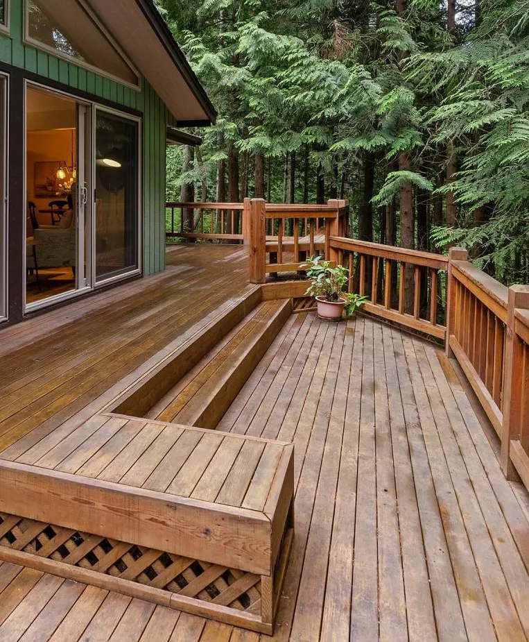 gorgeous green painted home with natural deck staining