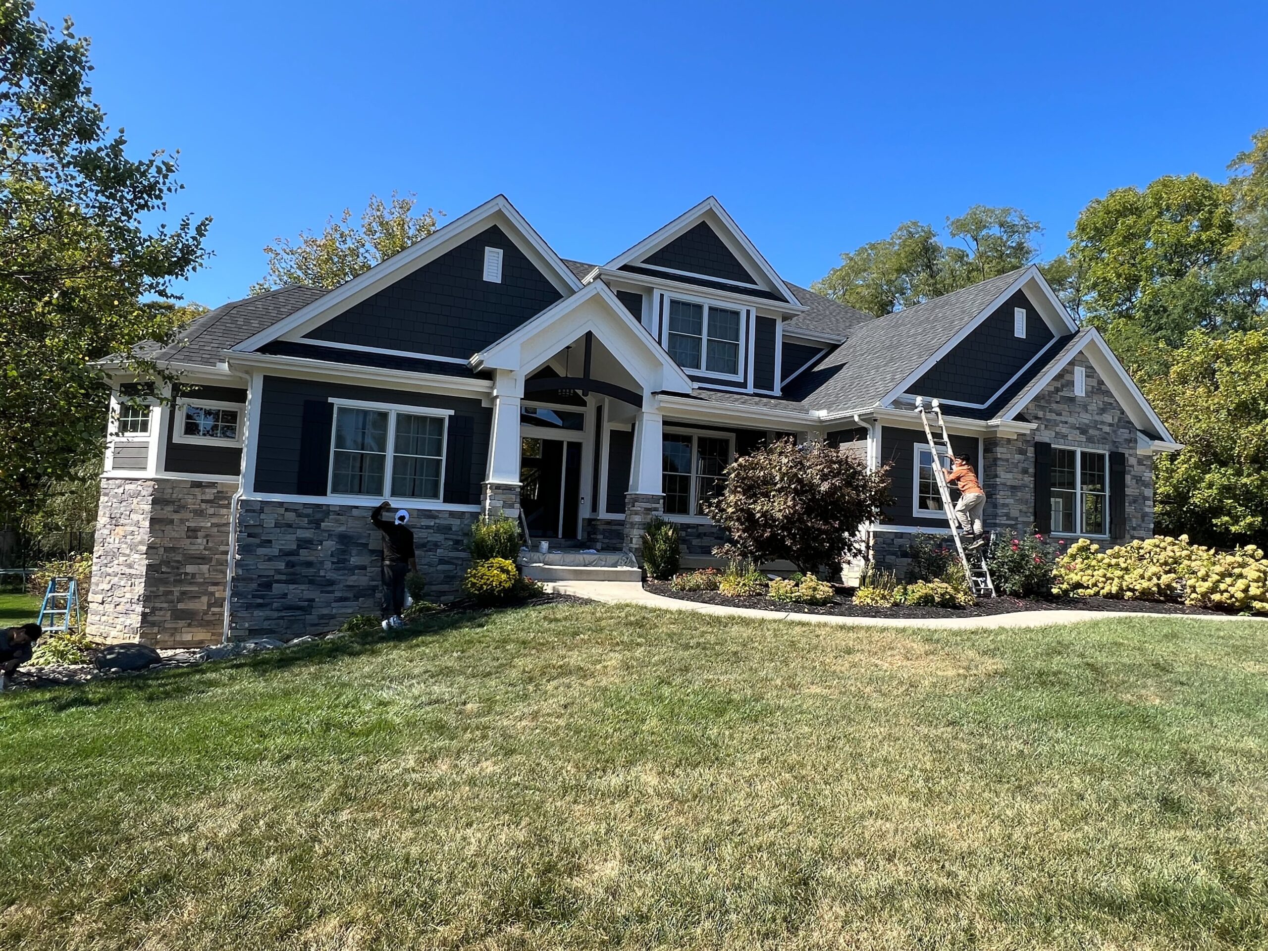 exterior painting for blue home with stone accents