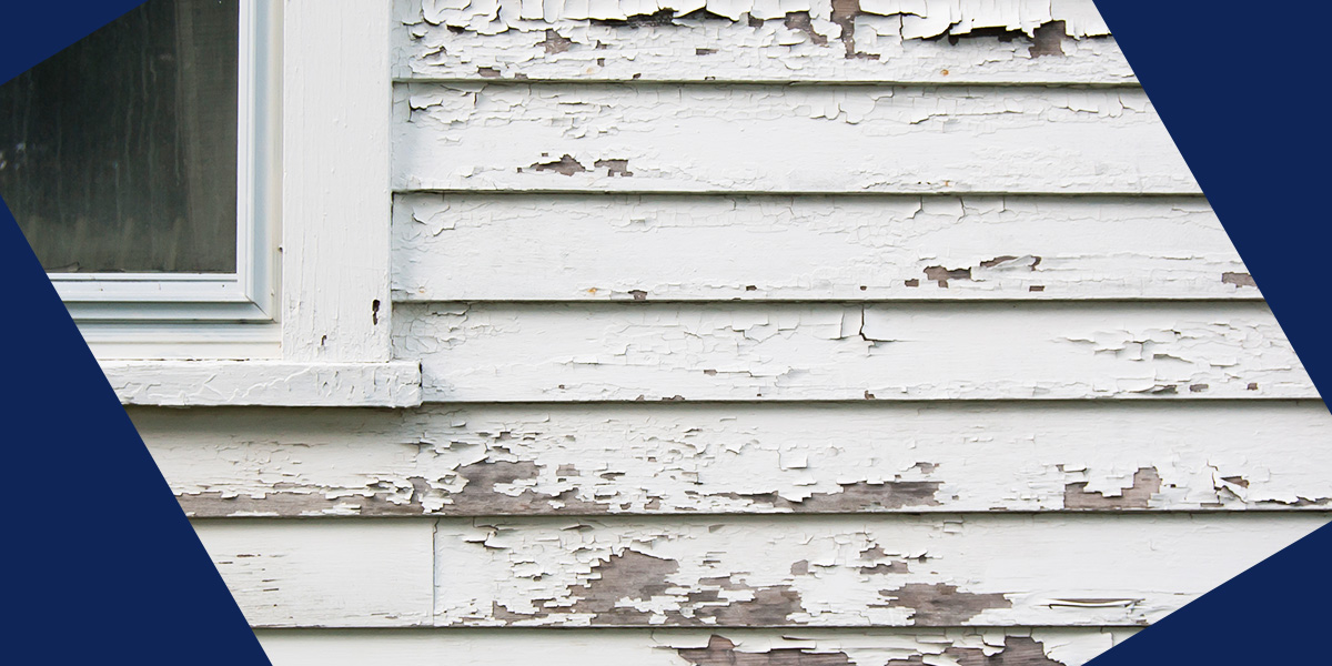 cracked paint on a home's exterior wood siding